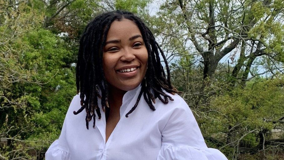 Closeup of blogger Shantell Lee with a crisp white shirt and dreads falling just past her shoulder